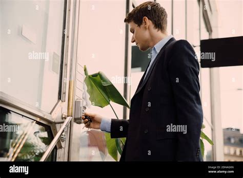Young Businessman Entering Keycode To Open Office Door Stock Photo Alamy