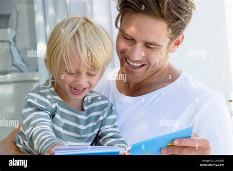 Happy Father And Son Reading A Book Stock Photo Alamy