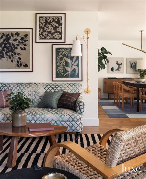 A Living Room Filled With Furniture And Pictures On The Wall