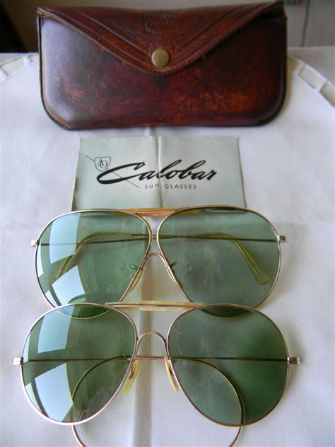 two pairs of vintage american optical calobar sunglasses ao