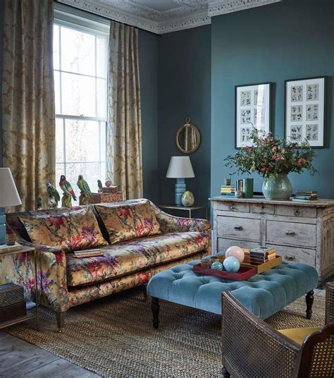 A Living Room With Blue Walls And Furniture In The Corner Including A