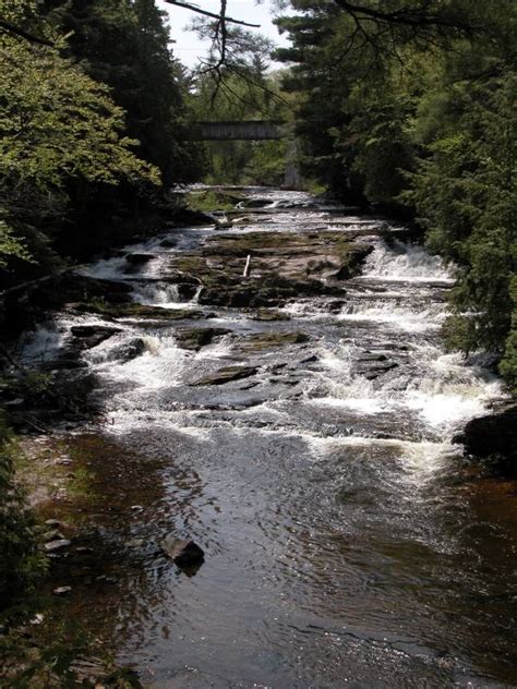 A river is a natural waterway that conveys water derived from precipitation from higher ground to lower levels. Falls River Falls