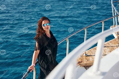 Mature Woman Standing On The Yacht And Enjoying Her Vacation On The Sea