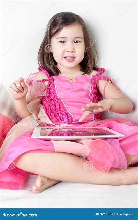 Eurasian Girl Plays On A Tablet Stock Photo Image Of Young Single