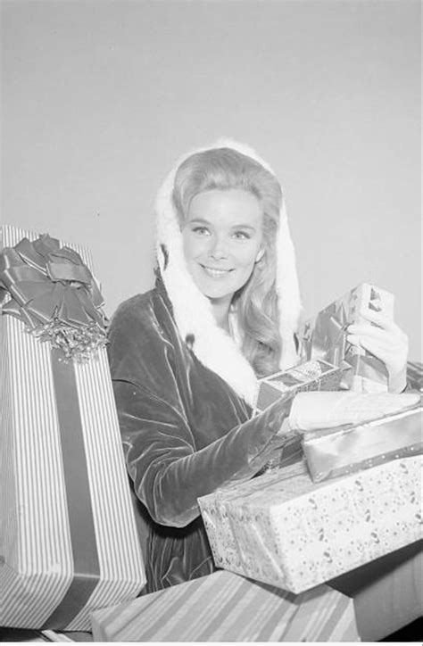 A Black And White Photo Of A Woman With Presents