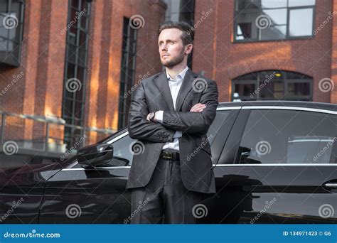 Attractive Successful Young Businessman In A Business Suit Near Stock