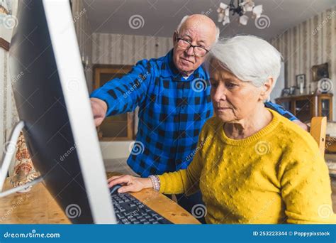 Senior Modern Experienced Man Standing Pointing At The Monitor And