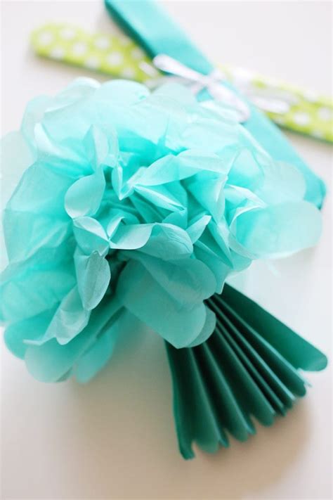 These tissue pom poms fill the space nicely and add some needed color and whimsy to her room. DIY Tissue Paper Pom Poms Backdrop - The Sweetest Occasion