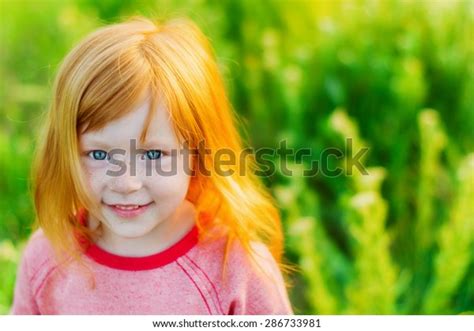 Portrait Of Beautiful Red Haired Girl With Big Blue Eyes And A Sweet