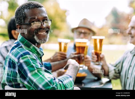 Group Of Senior Friends Drinking A Beer At The Park Lifestyle Concepts