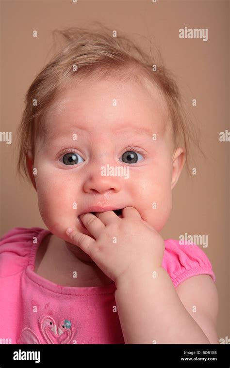 Baby Girl With Fingers In Her Mouth Stock Photo Alamy