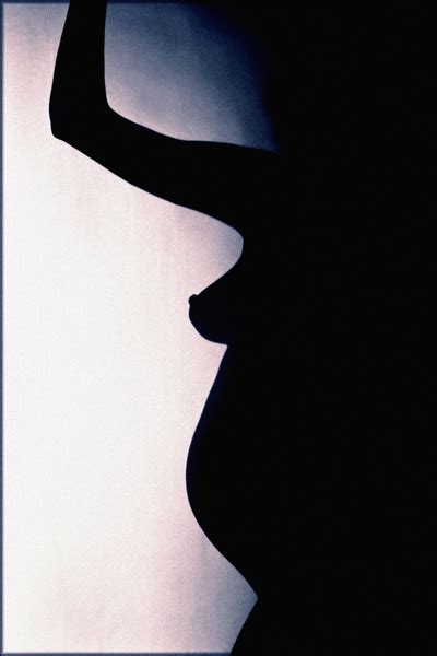 Pink Toned Silhouette Of Nude Pregnant Woman With Arm Raised Standing