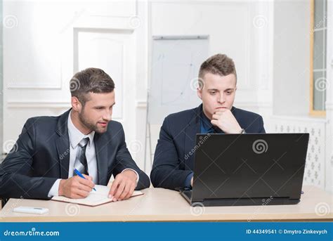Two Handsome Businessmen In Office Working On Some Stock Image Image