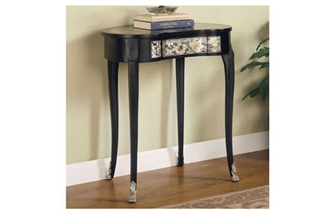 The 2 arched supports hold a triangle shaped glass tray. Kidney Shaped Accent Table dROPPED 12-29-10 at Gardner-White
