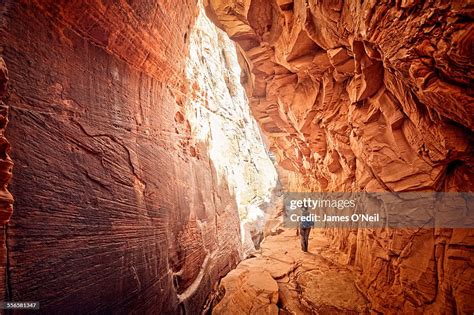 Female Hiker Walking Through Red Cave High Res Stock Photo Getty Images