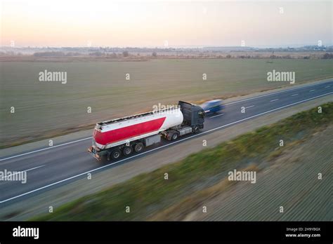 Aerial view of blurred fast moving fuel cargo truck driving on highway