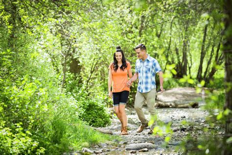 Couple Walking In The Woods Holding Hands Stock Photo Dissolve