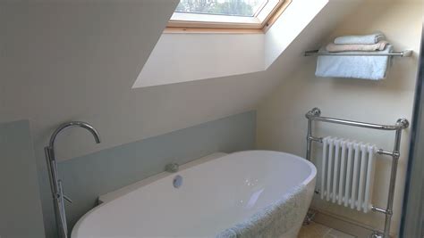 Attic Bathroom Under The Eaves With Large Velux Above The Freestanding