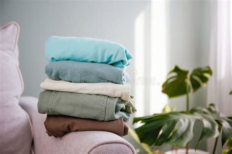 Pile Of Colorful Warm Clothes On The Grey Sofa Stock Photo Image Of