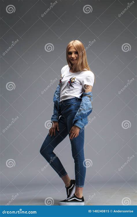 Beautiful Blonde Woman Dressed In A Denim Jacket And Blue Jeans Stock Image Image Of Beauty