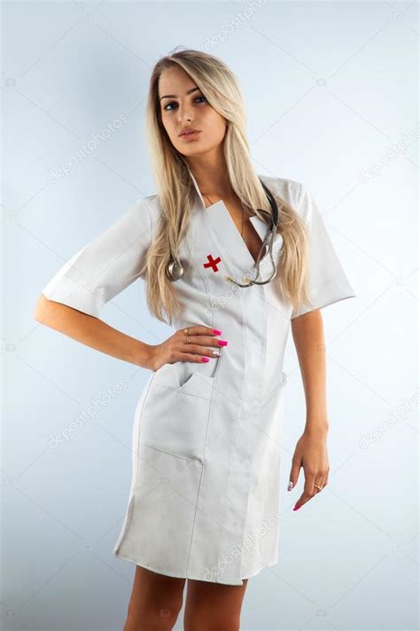 Adult Blonde Beautiful Nurse In White Medical Gown Stock Photo