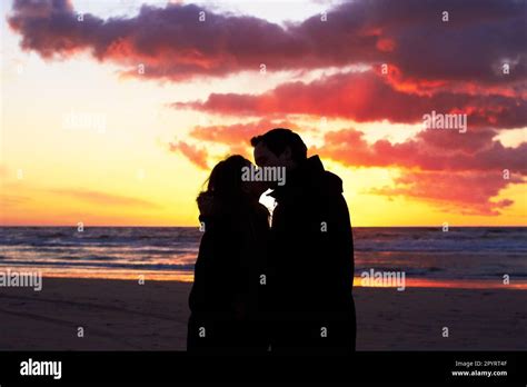 Beach Sunset And Couple Silhouette Kiss In Nature With Love Freedom And Romance Outdoors