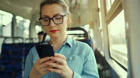 Woman In Tram Using Smartphone Chatting And Texting With Friends City