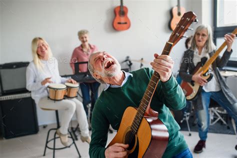 Group Of Senior People Playing Musical Instruments Indoors In Band