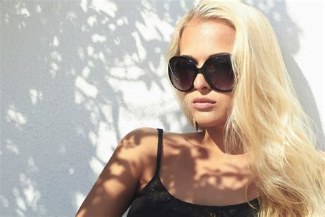 Beautiful Blond Woman Shadows On The Face Girl In Sunglasses Near The Wall Stock Image Image