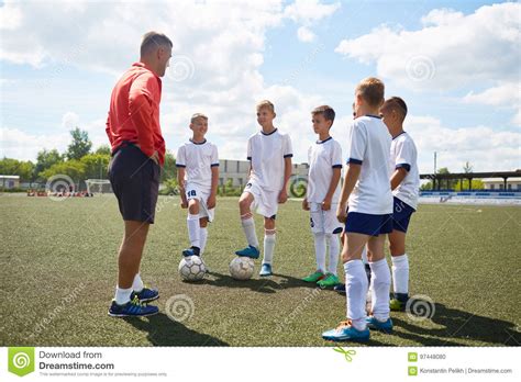Junior Football Team Listening To Coach Stock Photo Image Of