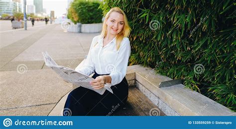 Lady Reading Newspaper Outdoors In With Close Up Face Stock Image