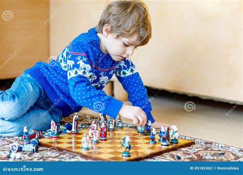 Little Preschool Kid Boy Playing Chess Game At Home Stock Photo Image