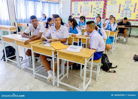 Thai Students In Their School Uniform Is Sitting By Each Other In Their