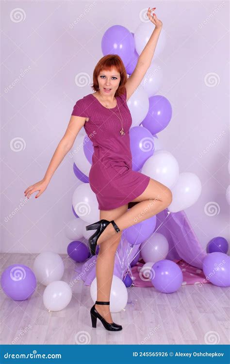 Beautiful Long Legged Redhead Girl In Violet Dress And Shiny Stockings