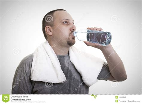 Sweaty Man Drinking Water After Exercise Stock Photo