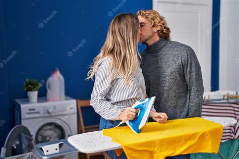 Premium Photo Man And Woman Couple Ironing Clothes Kissing At Laundry Room