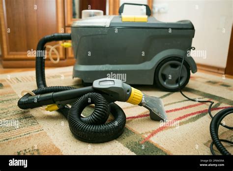 The Process Of Cleaning Carpets With A Steam Vacuum Cleaner The Carpet