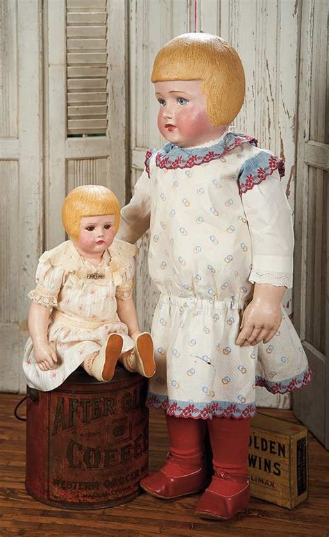 Two Dolls Are Posed Next To Each Other