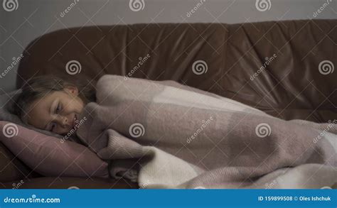 Sick Young Caucasian Girl Coughing While Lying Under Blanket At Home