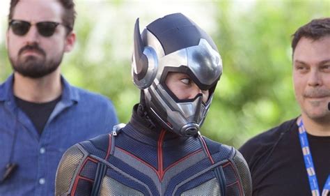 two men wearing ant man costumes stand next to each other