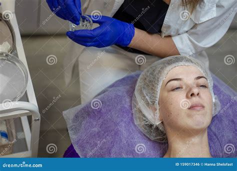 Beauty Clinicwoman Gets A Professional Facial Procedure Beautician Makes Massage On A Woman S