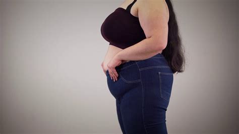 Side View Of Plump Caucasian Woman Showing Stretchable Jeans Fat Young