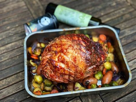 A Metal Container Filled With Food On Top Of A Wooden Table Next To A