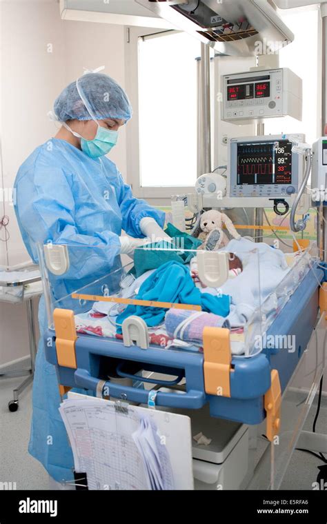 Pediatric Nurse Placing Drip To A Premature Newborn Baby Obstetrics