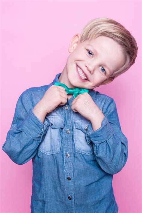 Young Beautiful Boy Blue Shirt Butterfly Tie Studio Portrait Over Pink