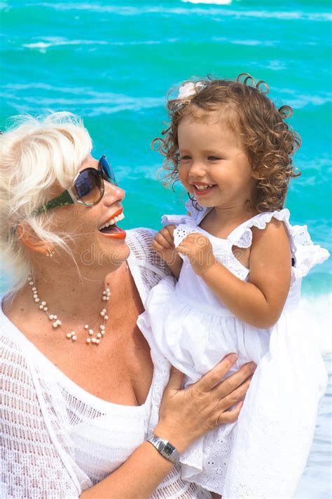 Grandmother And Granddaughter Are Having Fun On The Beach Stock Image Image Of Lifestyles