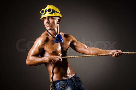Nude Builder Pulling Rope In Darkness Stock Image Colourbox
