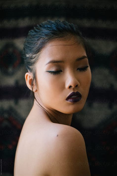 Asian Young Woman Wears Dark Purple Lipstick By Stocksy Contributor
