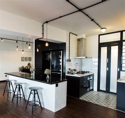 Dramatic herringbone wood look tile holds up to the high humidity and heavy traffic. black & white kitchen | Singapore HDB flat by JQ Ong/The ...