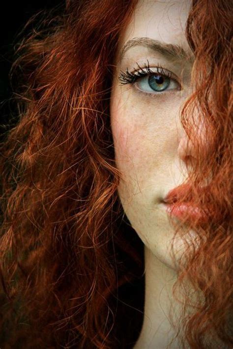 A Woman With Red Hair And Blue Eyes